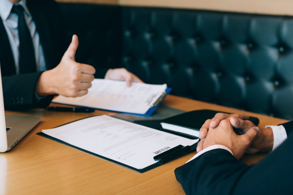 Job interviewer give a thumbs-up for job applications for new employee in the office room.