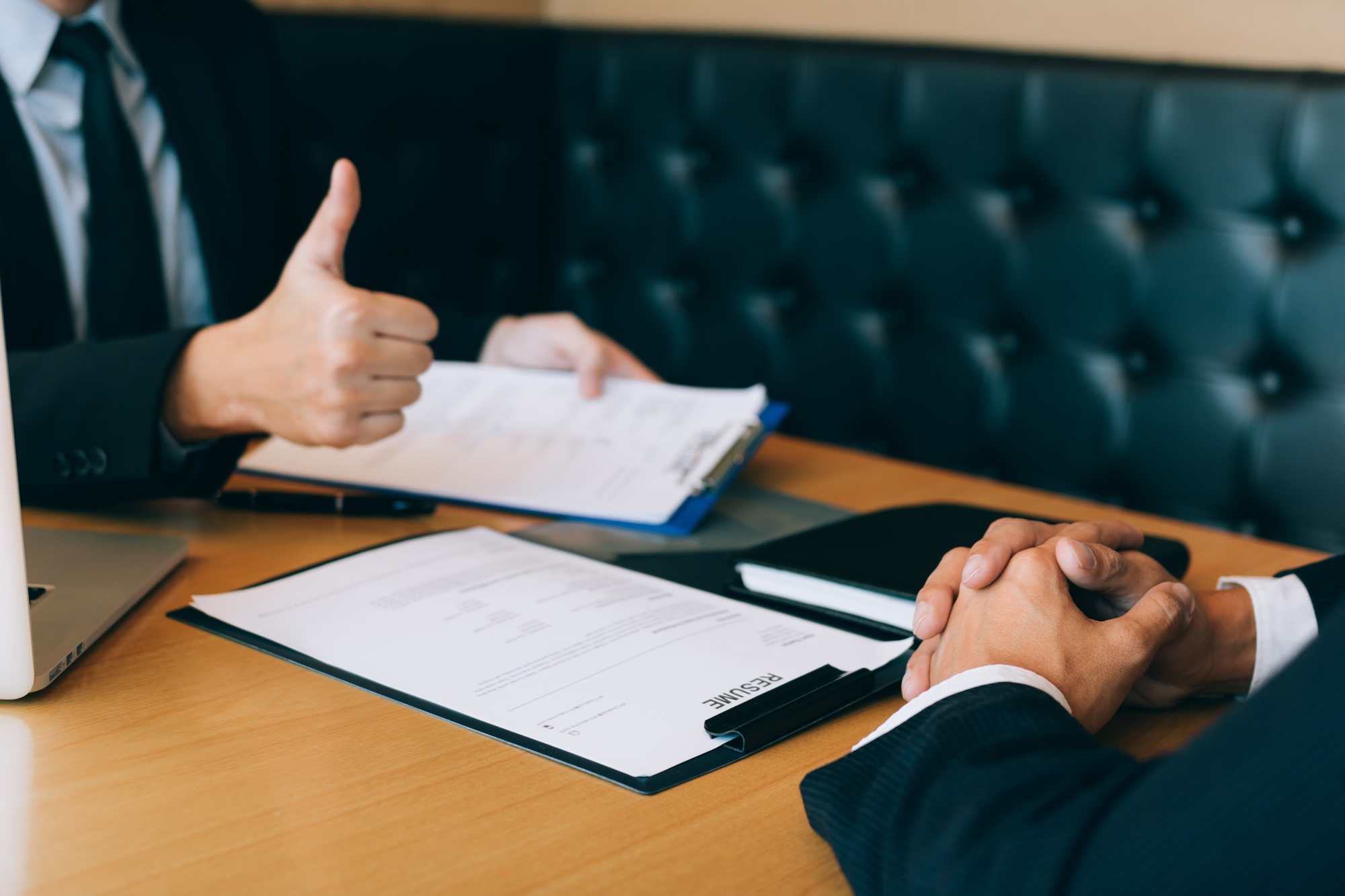 Job interviewer give a thumbs-up for job applications for new employee in the office room.