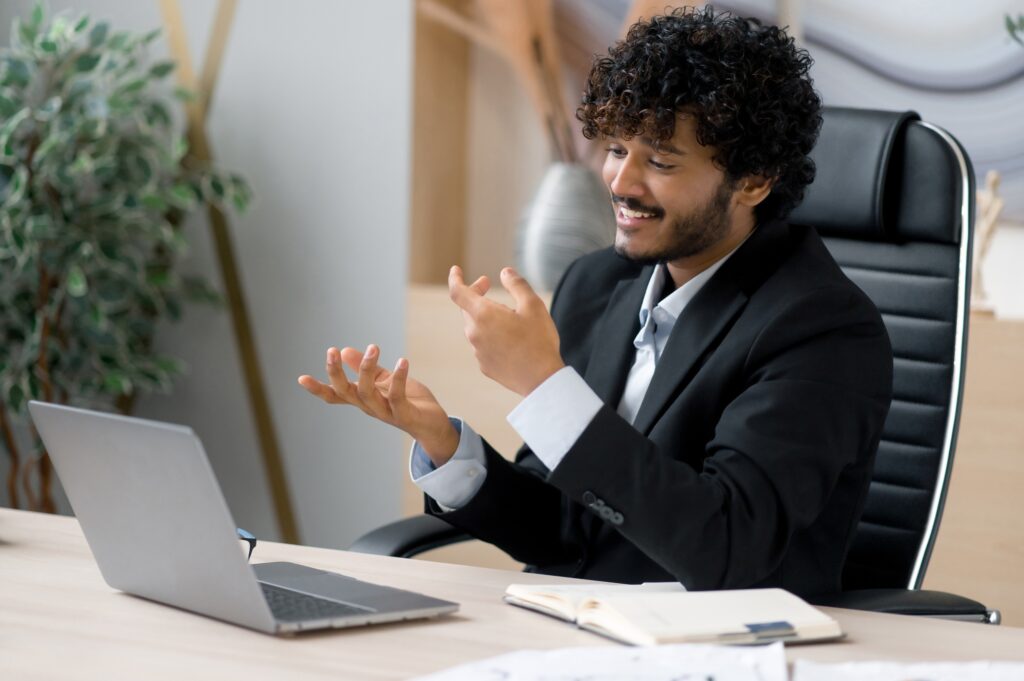 Successful Indian businessman, manager or business coach, communicates with colleagues online